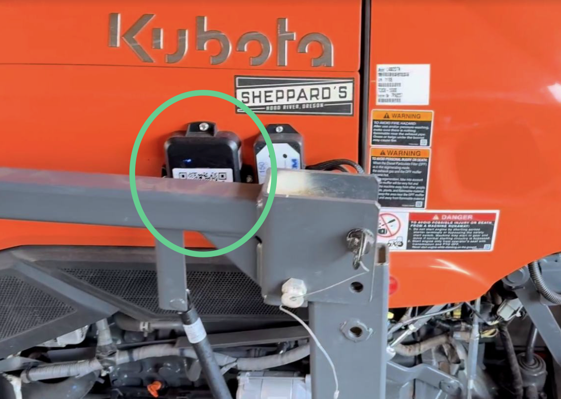 GPS device secured in cab with QR sticker attached